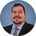 Rich Byzcek, Global Chief Engineer, Batteries at Intertek in front of a plain blue circular background